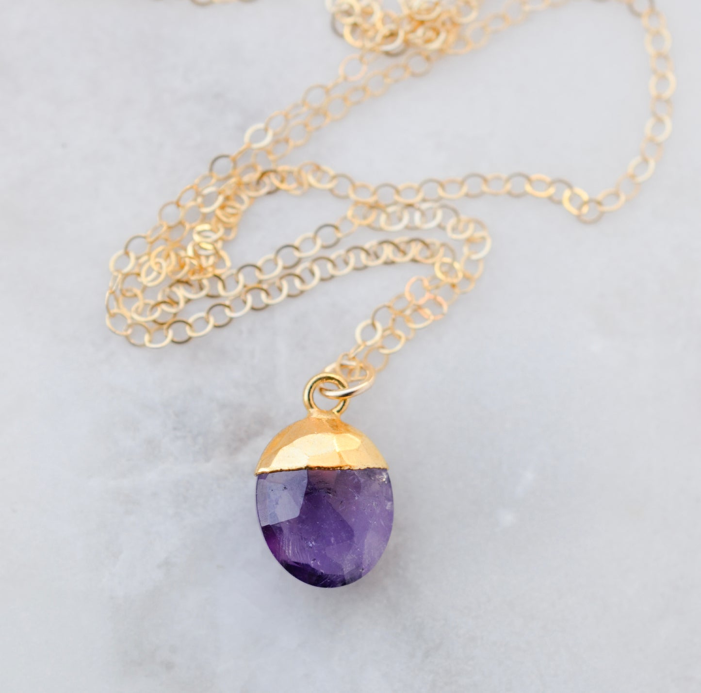 Necklace with a purple amethyst teardrop pendant and gold filled chain. Natural gemstone jewelry.