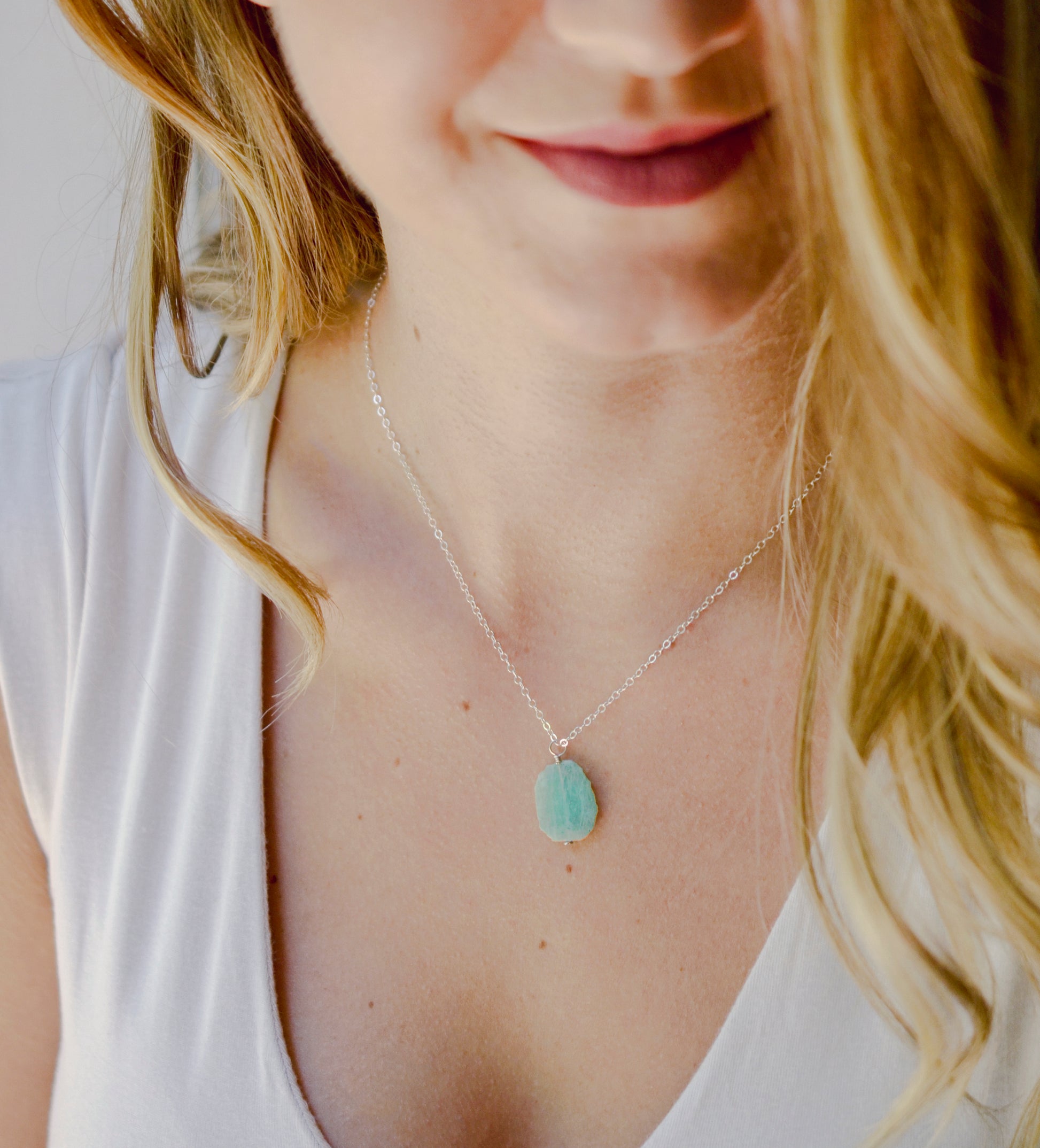 Natural raw Amazonite crystal slice set onto a sterling silver chain. Modeled image.