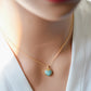 Natural blue green Amazonite gemstone pendant set on a 14k gold filled chain. The stone is a faceted heart shape and bezeled in 22k gold electroplate. Modeled image.