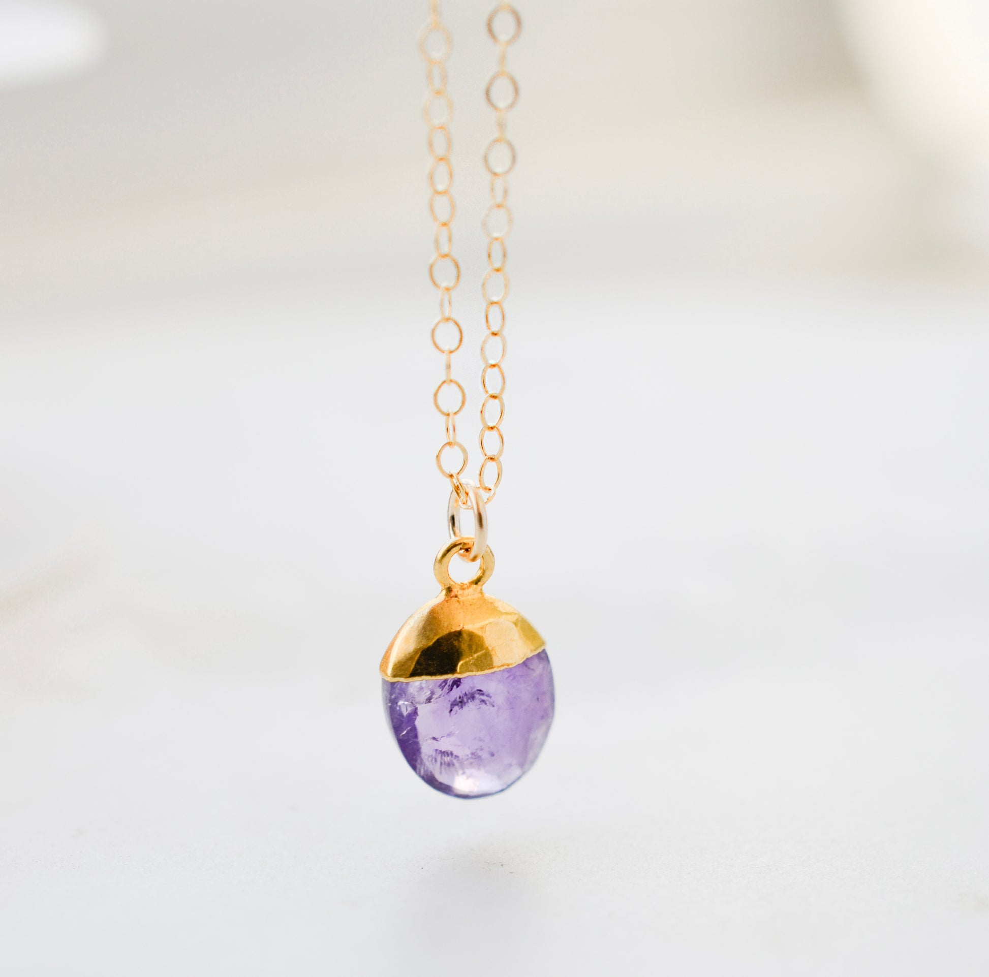 A natural purple amethyst oval drop necklace pendant. Handmade in Connecticut in 14k gold filled or sterling silver.
