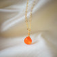 A small, natural orange Carnelian gemstone teardrop pendant suspended from a 14k gold filled cable chain. This necklace is handmade and also comes in sterling silver.