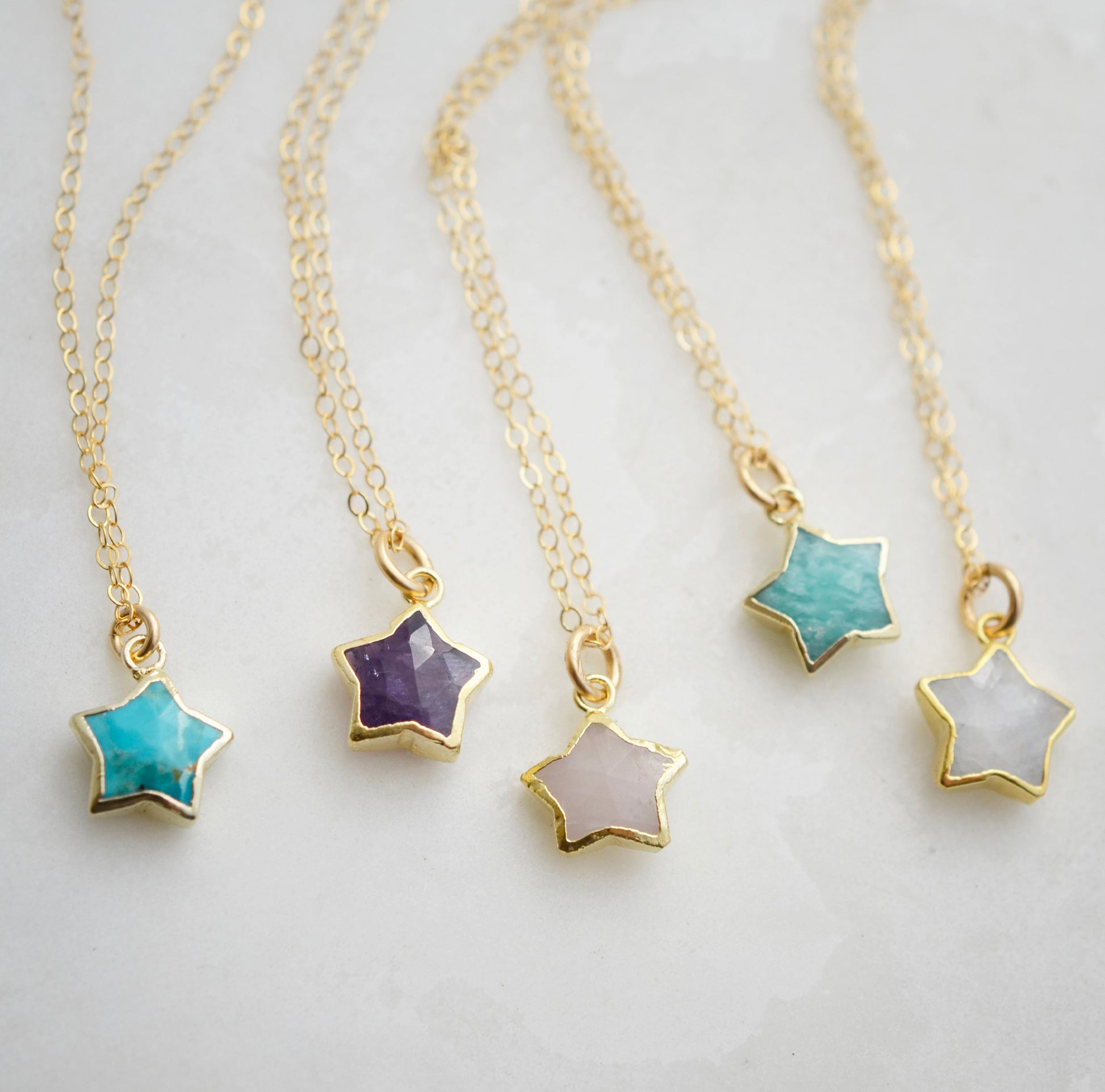 Star necklaces shown in a variety of stones.