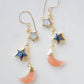 Mother of pearl, Labradorite, and Peach Moonstone moon and star dangle earrings in gold. Each earring has two stars hanging over a peach moonstone crescent.