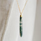 Long green, white, and clear real natural moss agate stone set on a 14k gold filled chain. The pendant is a long thin oval shape.