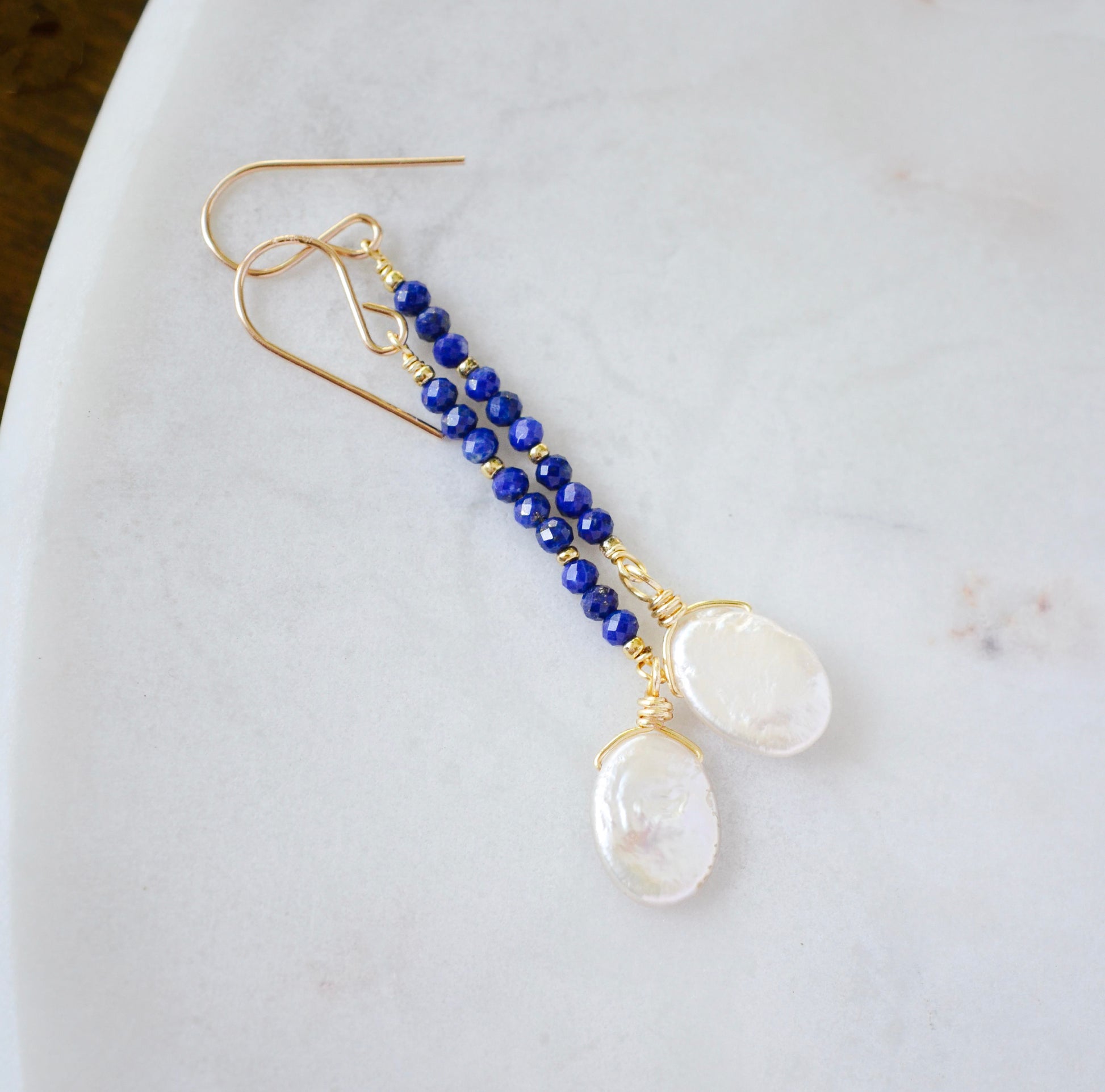 Natural blue lapis lazuli gemstone and white freshwater pearl long dangle earrings. The dangles are long and thin with oval freshwater pearls at the end. They come in 14k gold filled and sterling silver and a great gift for mom, girlfriend, anniversary, or yourself. 