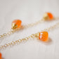 Handmade necklace featuring nine natural Carnelian gemstones set onto a gold filled chain. Sterling Silver is also available. Close up image.