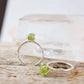 Raw green peridot ring on a sterling silver band. Close up image.