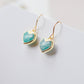 Aqua blue Amazonite gemstone heart earrings in gold. Modeled image. Natural Stones.