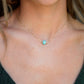 Genuine aqua blue Amazonite gemstone cut into a faceted cube and suspended on a gold filled cable chain. Modeled Image.