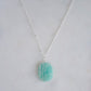Aqua blue amazonite slice gemstone set onto a sterling silver chain. The stone is semi oval in shape, but irregular. It's smooth polished, but with raw edges. 