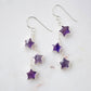 Long silver amethyst star dangle earrings. Three stars hang from a dainty chain beneath sterling silver earring hooks.