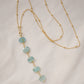 Genuine aqua blue Apatite gemstones set onto a beaded gold chain.