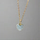 Pale blue natural aquamarine gemstone heart pendant set on a 14k gold filled chain. The stone is genuine and faceted with a 22k gold electroplate bezel.