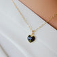 Black onyx heart pendant set on a 14k gold filled chain necklace. The crystal is faceted.