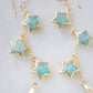 Blue celestial, amazonite star earrings in gold with rainbow moonstone crescents. Each earring has three gemstone stars and one moon dangling from it.