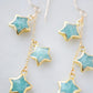 Amazonite faceted gemstone stars suspended from a dainty gold chain. Close up image.