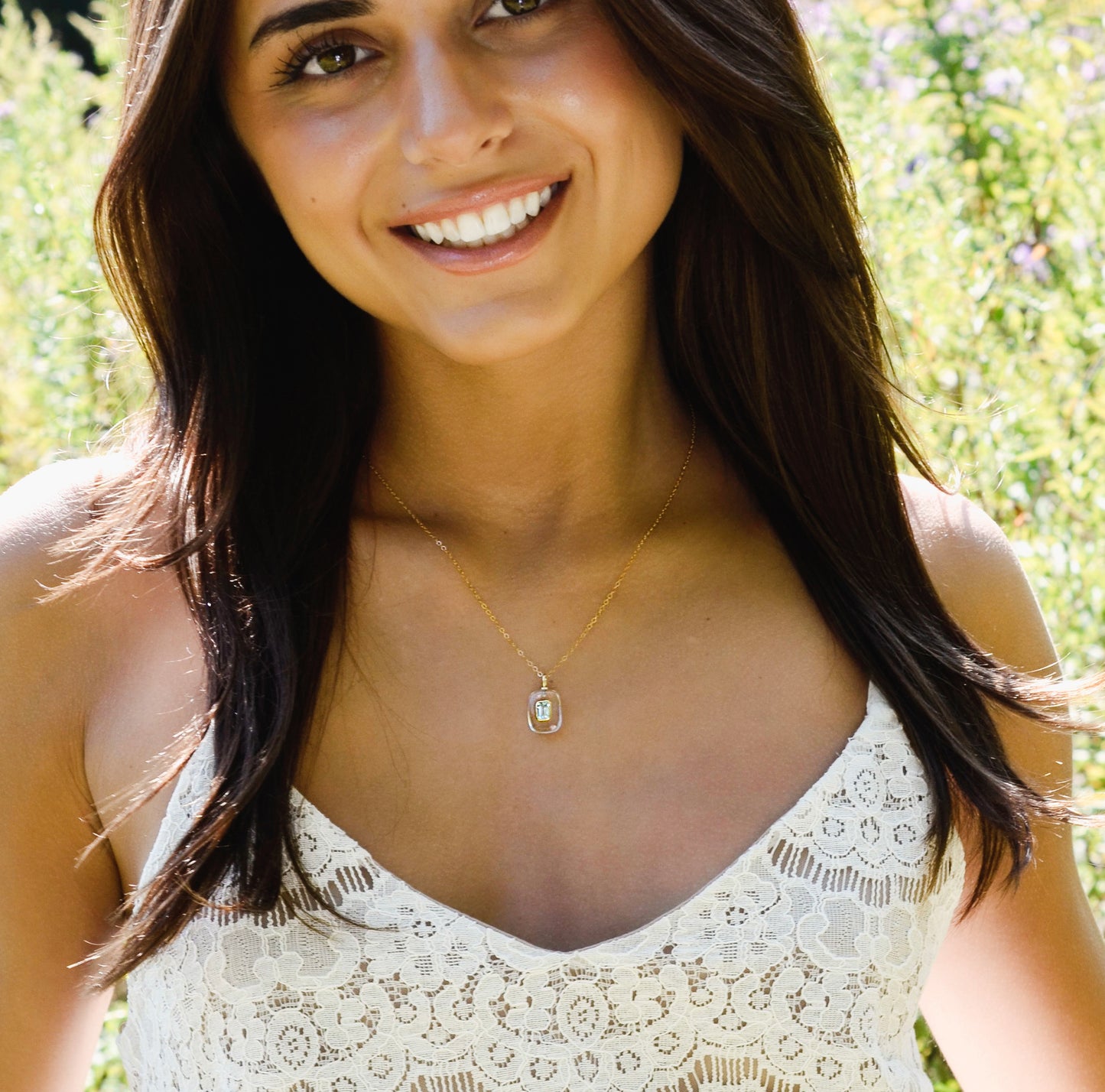 Modeled image with an 18 inch length. Handmade Maris necklace featuring a Blue Topaz set inside a clear Rock Crystal frame on a 14K Gold Filled chain. Ideal gift for wife, girlfriend, or mom. Minimalist topaz pendant for layering.