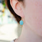 Modeled image of a woman wearing natural round coin shaped blue turquoise earring dangles in 14k gold filled.