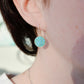 Modeled image of a woman wearing natural round coin shaped blue turquoise earring dangles in 14k gold filled.