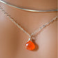 A sterling silver necklace handmade with natural, genuine, orange Carnelian crystal. This necklace is modeled with a chain choker and is also available in a dainty 14k gold filled chain.