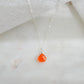 A dainty, real orange Carnelian gemstone teardrop pendant suspended from a sterling silver cable chain. This necklace is handmade and also comes in 14k gold filled.