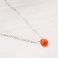 Handmade orange Carnelian Necklace. A single teardrop gemstone placed onto a sterling silver or gold filled chain. Modeled image.
