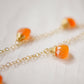 Handmade necklace featuring nine natural Carnelian gemstones set onto a gold filled chain. Sterling Silver is also available. Close up image.