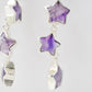 Sterling silver celestial amethyst star earring jewelry. Each earring features three purple amethyst stars dangling from a sterling silver chain.