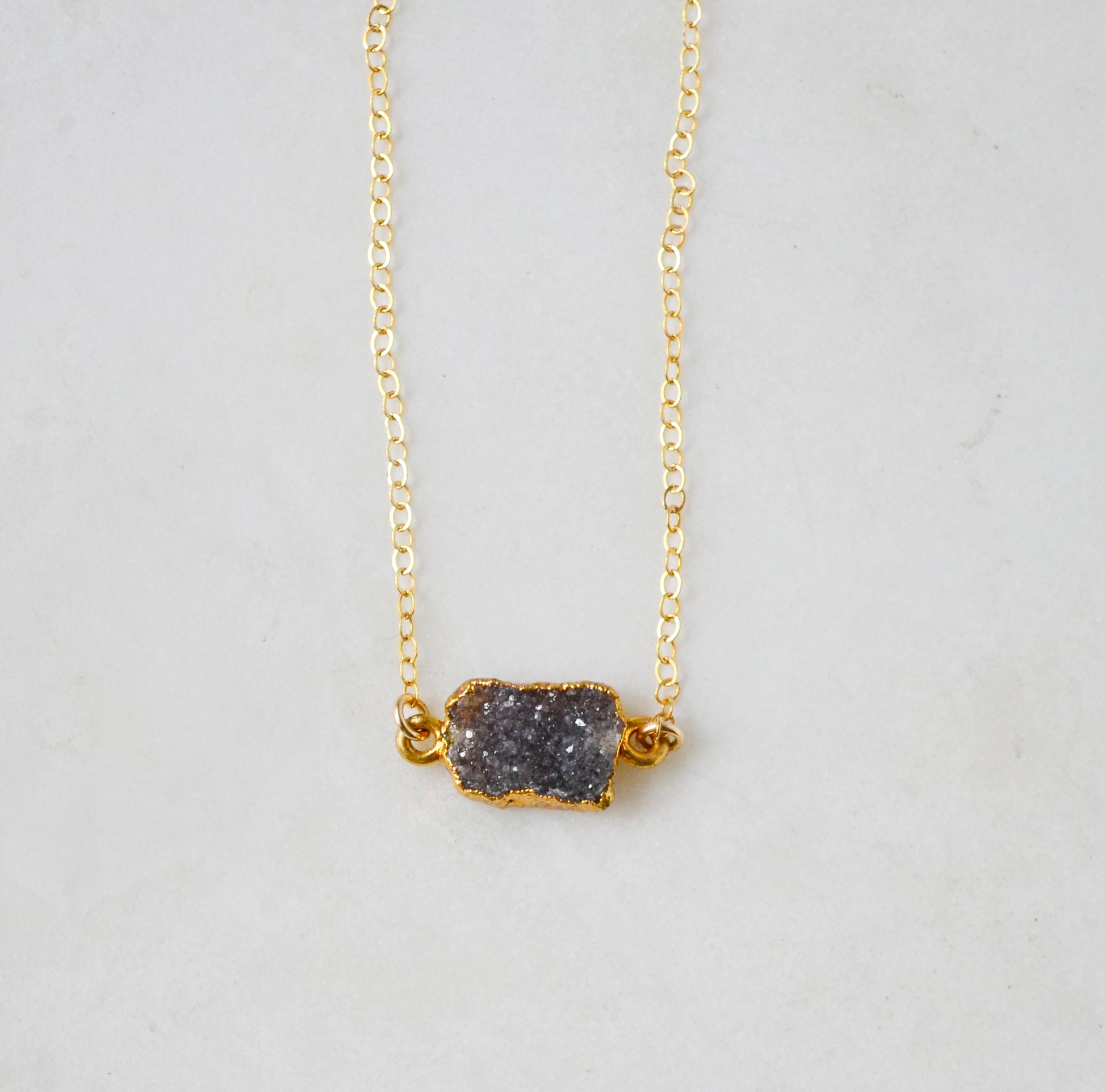 Handmade necklace with a dark gray quartz druzy gemstone pendant on a 14k gold filled chain.