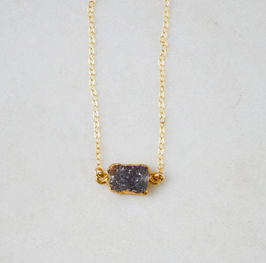 Handmade necklace with a dark gray quartz druzy gemstone pendant on a 14k gold filled chain.