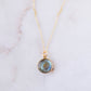Round natural blue labradorite donut shaped pendant set on a 14k gold filled chain. This necklace is handmade by Gemnia Jewelry in Connecticut.