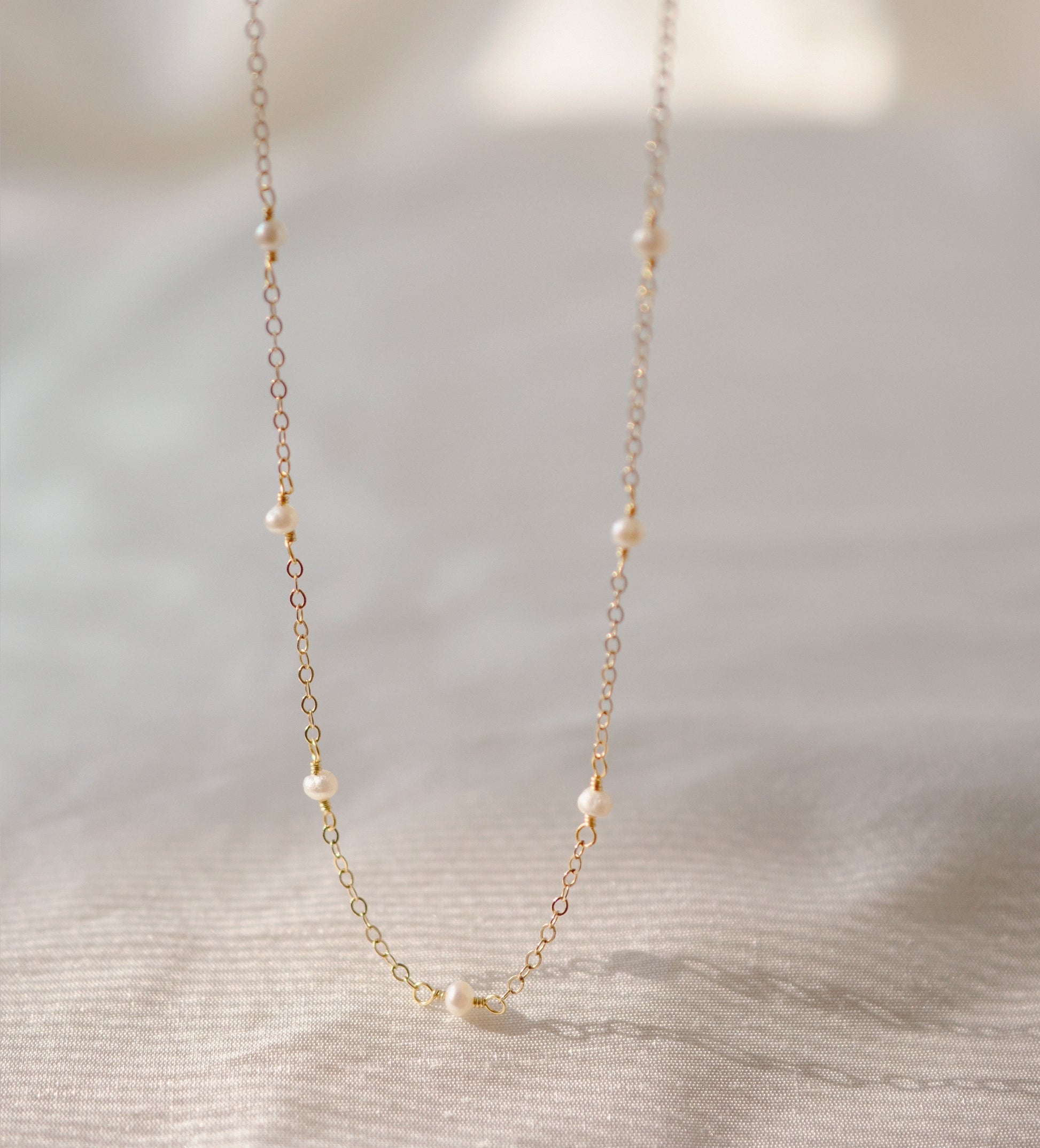 Genuine white freshwater pearls set onto a 14k gold filled chain. 