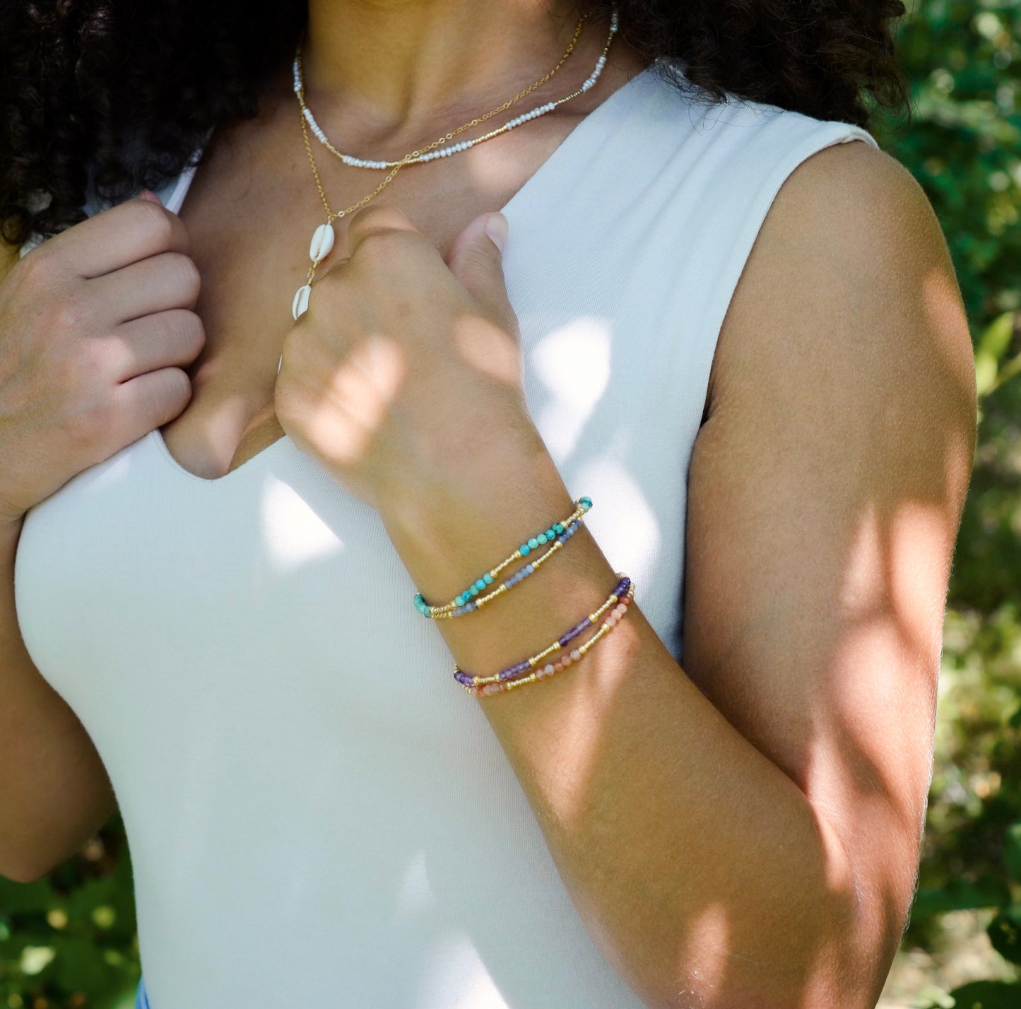 Handmade beaded gemstone crystal bracelet in gold filled or sterling silver. These bracelets feature a gemstone of your choice on a bracelet that can be stacked with others or worn alone. Modeled image.