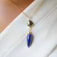 Close up image. This necklace is handmade with natural pyrite and lapis lazuli suspended from a 14k gold filled or sterling silver chain.