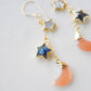 Mother of pearl, Labradorite, and Peach Moonstone moon and star dangle earrings in gold. Each earring has two stars hanging over a peach moonstone crescent. Close up.