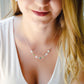 Modeled image. A multi-color burma jade necklace featuring seven round green, brown, yellow, or blue natural stones. Handmade in Connecticut by Gemnia Jewelry.
