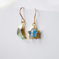 Labradorite Moon and Star earrings. One dangle is a faceted crescent moon, while the other is a star. The stones are naturally gray in color, but shift blue or green with movement. Available in gold or silver.