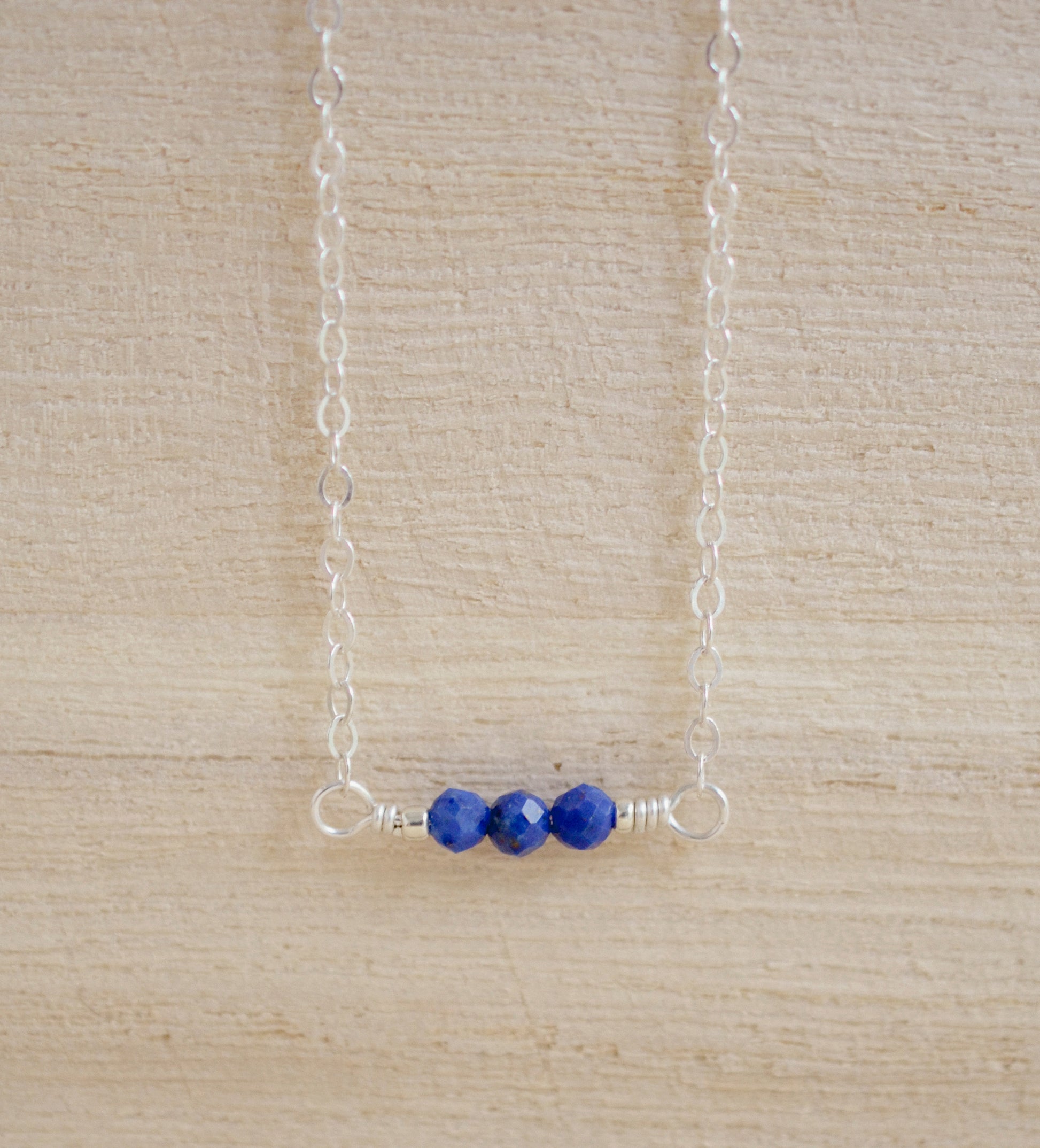 Three genuine Lapis Lazuli stones set onto a sterling silver chain. Handmade Jewelry by GEMNIA.