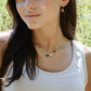Modeled image: Handmade dainty heart necklace with heart-shaped gemstones on a 14k gold filed chain. Stones include: Aquamarine, Rose Quartz, Amazonite, Larimar, Labradorite, Amethyst, and Rainbow Moonstone