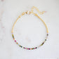 Tiny mulit-color Tourmaline faceted round crystals on a gold beaded bracelet. The adjustable style is shown.