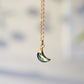 Necklace with a crescent moon pendant handmade with a natural labradorite gemstone set in gold. The chain is 14k gold filled.