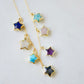 Necklace with star-shaped charms on a 14k gold filled chain. Each star is a different gemstone. Stones include: Lapis lazuli, rainbow moonstone, turquoise, labradorite, amethyst, rose quartz, and amazonite. This necklace is handmade in Connecticut by Gemnia.