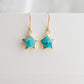 Celestial star earrings with turquoise stones set in gold. These dainty minimalist gemstone earrings are handmade by Gemnia Jewelry in Connecticut.