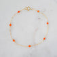 A gold-colored bracelet featuring orange carnelian stones on a 14k gold filled chain.