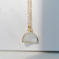 This necklace is handmade with a natural white druzy quartz pendant in a half-circle or crescent shape. Available in 14k gold filled.