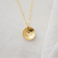 Om symbol stamped into a circle disc and put on a gold filled chain.
