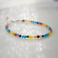 Tiny gemstone beaded bracelet in rainbow colors. Colors include: blue, green, yellow, red, orange, and purple.