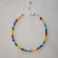 Tiny gemstone beaded bracelet in rainbow colors. Colors include: blue, green, yellow, red, orange, and purple.