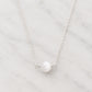 A genuine white selenite round stone set on a sterling silver chain. The crystal is smooth polished and handmade by Gemnia in New England.
