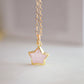 Dainty rose quartz star pendant necklace on a gold chain.